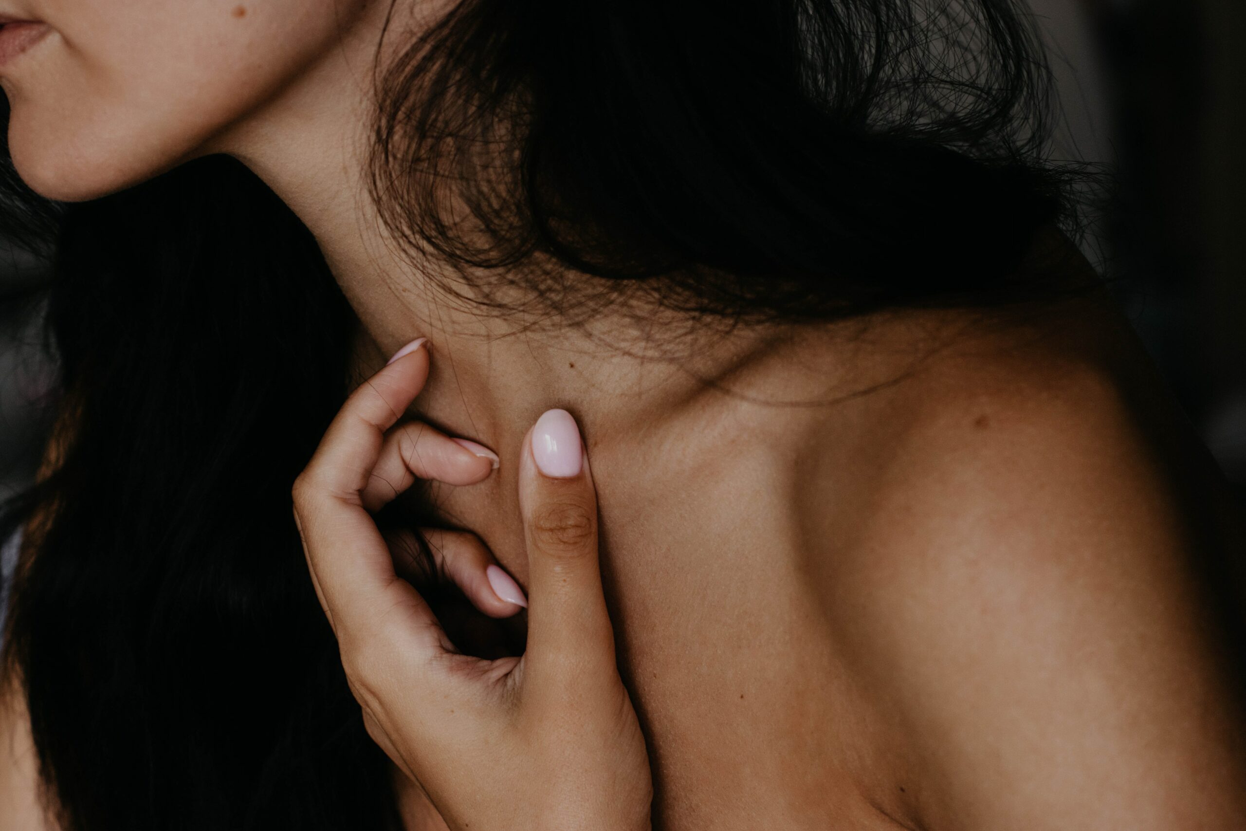 Hand resting at the collarbone